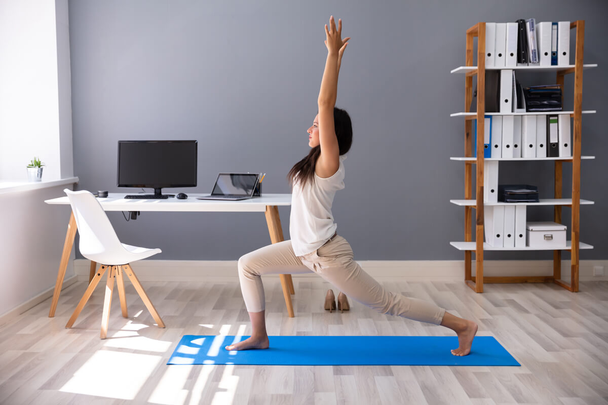 Woman in office doing yoga
