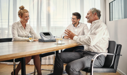 3 people talking with a BEMER Distributor
